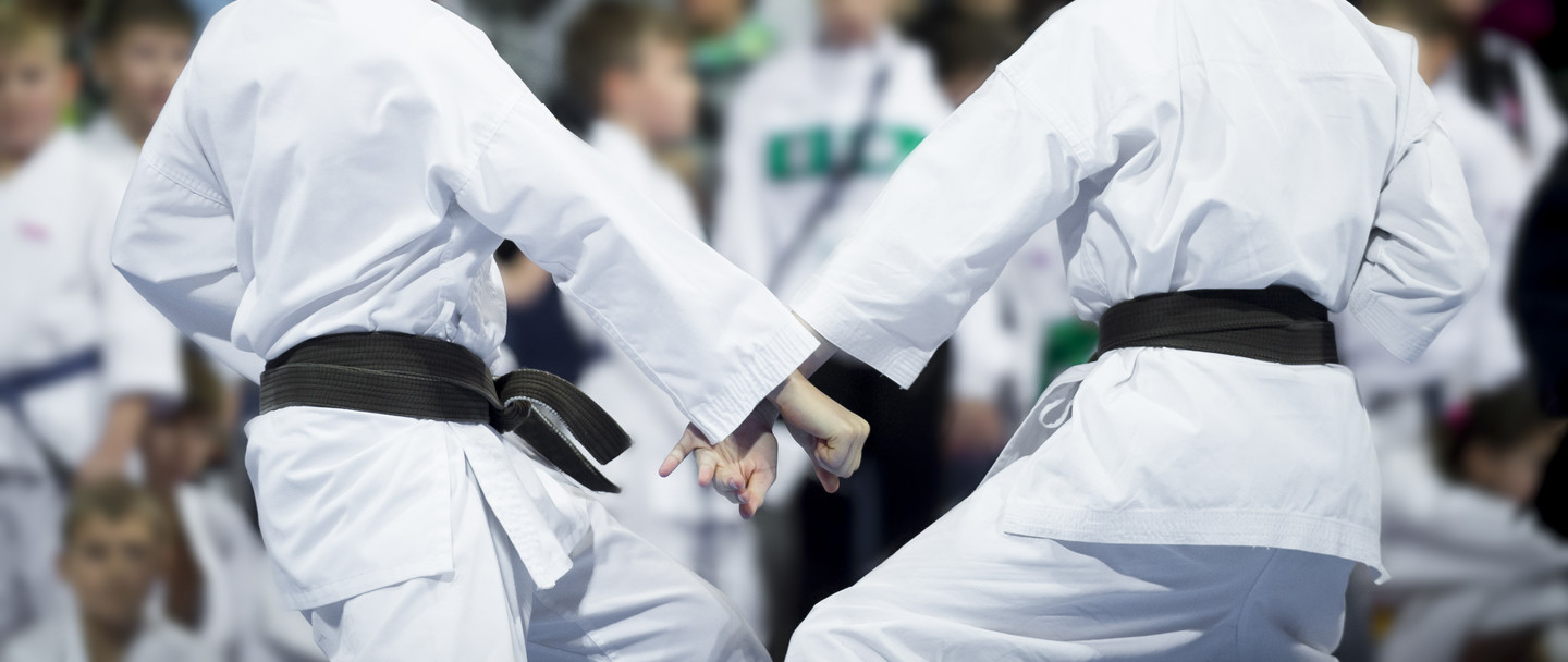 karate do kids fight on blur background. Sport competition